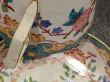 a cup and saucer sitting on a plate on a table