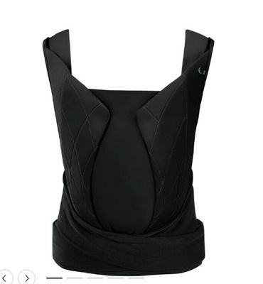 the back of a woman ' s black dress on a white background