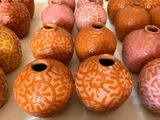 many different colored vases sitting on a table