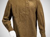 a mannequin mannequin wearing a brown shirt and white pants