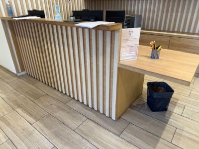 a desk with a trash can and a trash can on the floor