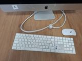 a keyboard, mouse, and monitor sitting on a desk