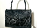 black alligator skin handbag on a white radiator radiator radiator radiator radiator radiator radiator radiator