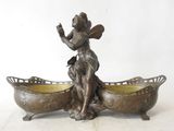 a bronze statue of a woman sitting in a boat
