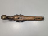 a close up of a wooden toy gun on a white surface
