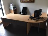 a desk with two computers on it in a room