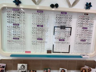 a display of glasses on the wall in a store