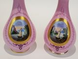 pair of pink vases with a picture of a ship on them