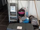a lot of cleaning supplies on the floor in the room