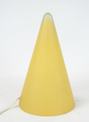 a yellow cone shaped lamp on a white surface