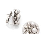 a close up of a pair of earrings on a white surface