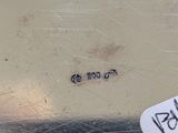a white tag that is on the side of a metal container