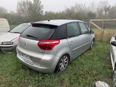 a silver car that is parked in the grass