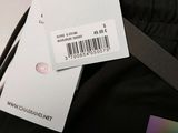 the back of a pair of black pants with a tag on it