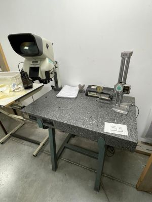 an image of a workbench with a microscope on it