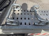 a close up of a truck bed with a couple of metal bars on it