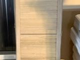a stack of towels sitting on a shelf in a room