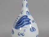 a blue and white vase with a bird design on it
