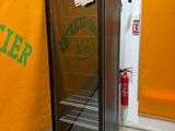 a refrigerator with a sign on it in the corner of a room