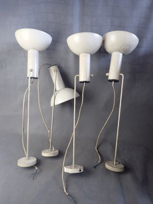 three white floor lamps on a gray background with a blue background