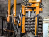 an image of a machine that is working on a piece of metal