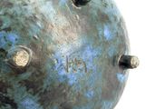 a close up of a metal object on a white surface