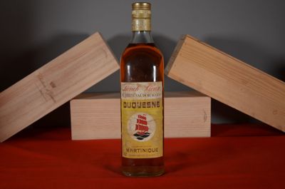 a bottle of liquor sitting on a table next to a wooden box