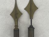 pair of antique brass arrows on a white background