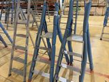 many ladders that are sitting in the middle of a room