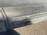 a close up of a car ' s bumper with a hole in it
