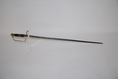 a sword that is laying on a white surface
