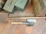 a shovel sitting on the floor next to a box and a shovel