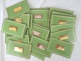 a lot of green and gold cards on a white table