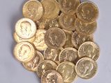 a pile of gold coins sitting on a white surface