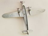 a small model of a plane hanging on a wall