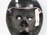 an image of a black mask with a tag on it ' s forehead