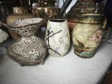 three vases sitting on a table next to each other