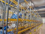 a large warehouse filled with lots of shelves and pallets