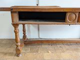 a wooden table with a drawer on top of it