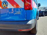 a blue van with red and white stripes parked in a parking lot