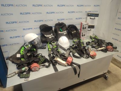 several pairs of skis and helmets on a table in front of a wall