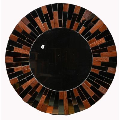 un miroir rond orné d'un motif noir et marron