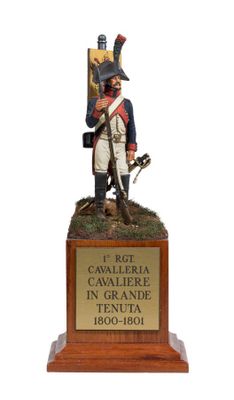 figurine of a soldier with a sword and shield on a wooden base