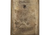 an old silver bar with the name of a man on it