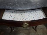 a marble top table with a drawer underneath it