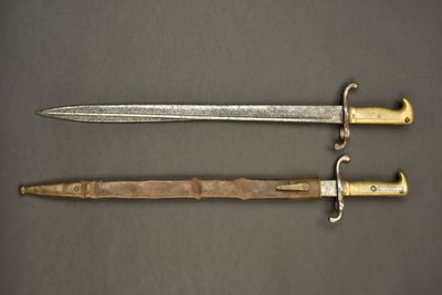 two swords with gold and silver on a black background
