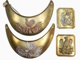 three pieces of brass with a bird on them
