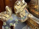 a statue of a cat sitting on top of a table