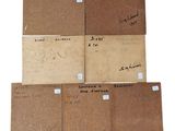 six pieces of cardboard with writing on them sitting on top of each other