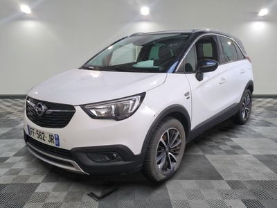 the white opel suv is parked in a room with a checkered floor